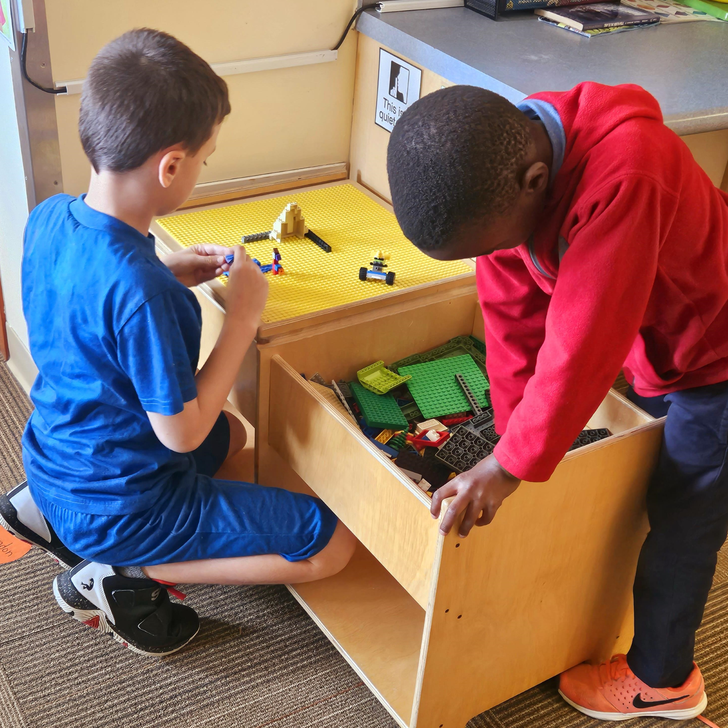 School age boys playing at LEGO table