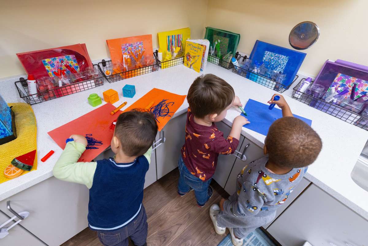 Toddlers coloring with markers on paper